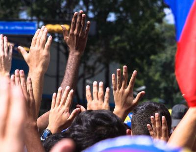 web3-venezuela-protest-flag-hands-people-hugo-londoc3b1o-cc-by-sa-2-0