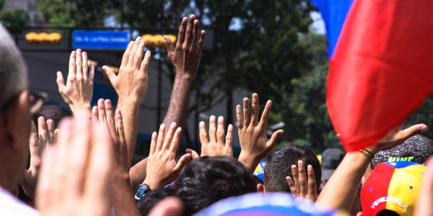web3-venezuela-protest-flag-hands-people-hugo-londoc3b1o-cc-by-sa-2-0
