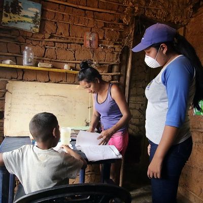 A teacher visits student at home after the closing of schools during the nationwide quarantine due to coronavirus disease (COVID-19) outbreak in El Pao